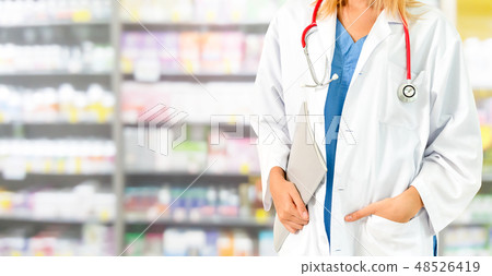 Woman pharmacist working at pharmacy. 48526419