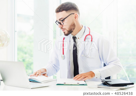 Doctor working on laptop computer hospital. Doctor working on laptop computer hospital. 48526438