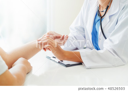 Woman Doctor and Female Patient in Hospital Office Woman Doctor and Female Patient in Hospital Office 48526503
