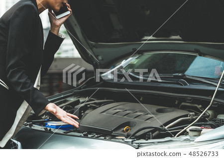 Woman whose car breakdown call for repair service. Woman whose car breakdown call for repair service. 48526733