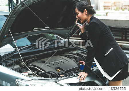 Woman whose car breakdown call for repair service. Woman whose car breakdown call for repair service. 48526735