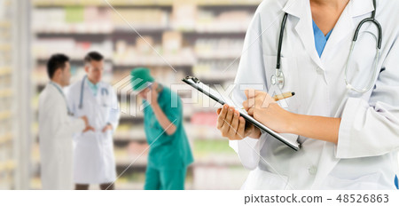 Doctor working in hospital with other doctors. Doctor working in hospital with other doctors. 48526863