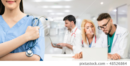 Doctor working in hospital with other doctors. Doctor working in hospital with other doctors. 48526864