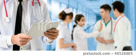 Doctor working in hospital with other doctors. Doctor working in hospital with other doctors. 48526865