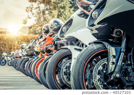 Motorcycles group parking on city street in summer Motorcycles group parking on city street in summer 48527103