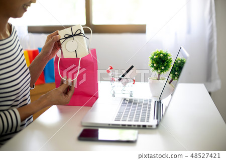 woman sit at computer table look at the product woman sit at computer table look at the product 48527421