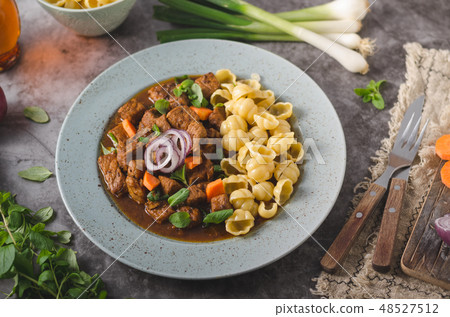 Goulash stew slow cook with pasta Goulash stew slow cook with pasta 48527512