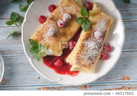 Cheese blintzes pancakes with fresh fruit Cheese blintzes pancakes with fresh fruit 48527602