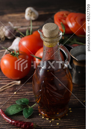 Homemade olive oil with tomatoes and chilli 48527709