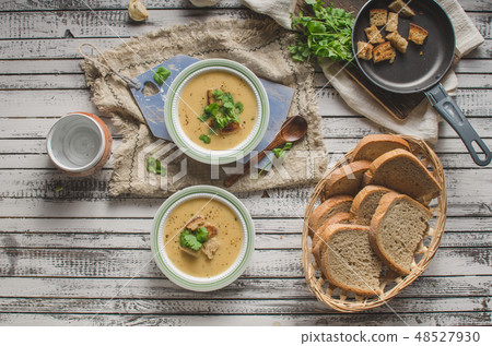 Creamy mushroom soup with fresh herbs garlic croutons Creamy mushroom soup with fresh herbs garlic croutons 48527930
