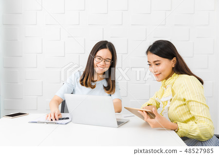 Two Asian architect ladies at office Two Asian architect ladies at office 48527985