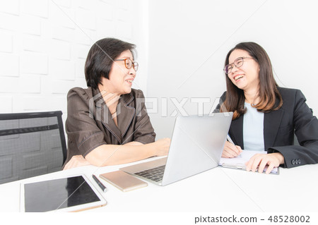 Asian woman working Asian woman working 48528002