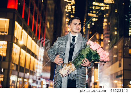 man walking to the date with rose flower bouquet 48528143