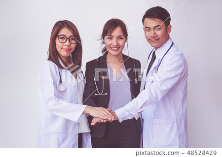 Doctors and Nurses coordinate hands.  48528429