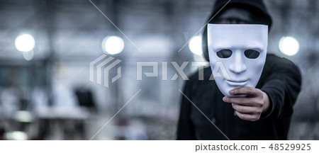 Mystery hoodie man holding white mask 48529925
