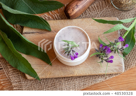 A jar of homemade comfrey root ointment A jar of homemade comfrey root ointment 48530328