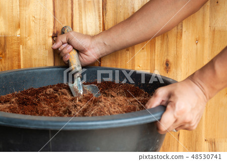 Man hands preparing soil for planting Man hands preparing soil for planting 48530741