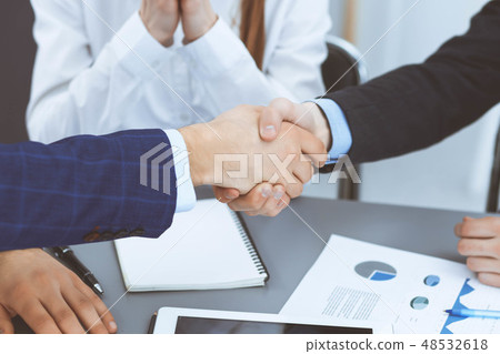 Business people shaking hands, finishing up a papers signing. Meeting, agreement and lawyer Business people shaking hands, finishing up a papers signing. Meeting, agreement and lawyer 48532618