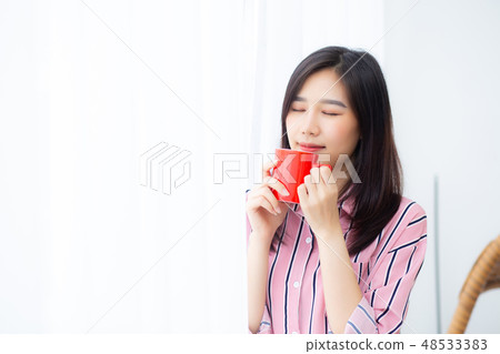 Beautiful asian woman with drink a cup of coffee Beautiful asian woman with drink a cup of coffee 48533383