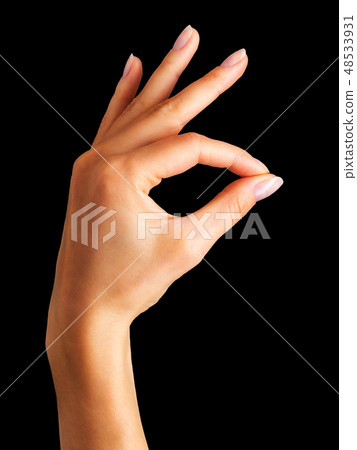 Woman hand holding something with two fingers 48533931