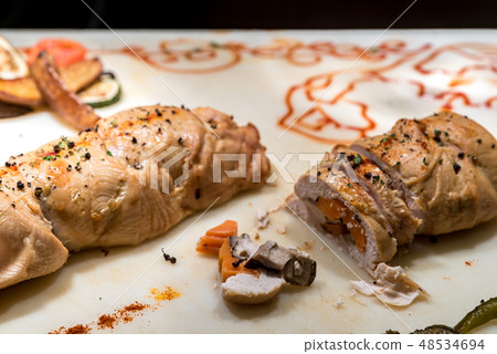 Carving of stuffed chicken breast 48534694