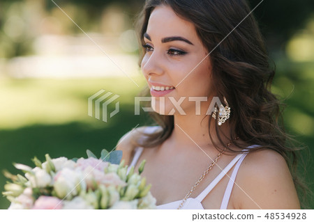 Portrait of yound girl with bouquet. Charming lady in sunny summer day. Stylish woman Portrait of yound girl with bouquet. Charming lady in sunny summer day. Stylish woman 48534928