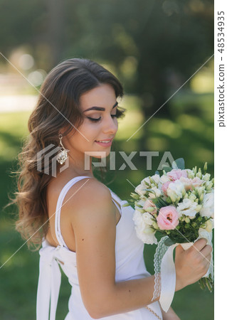 Portrait of yound girl with bouquet. Charming lady in sunny summer day. Stylish woman Portrait of yound girl with bouquet. Charming lady in sunny summer day. Stylish woman 48534935