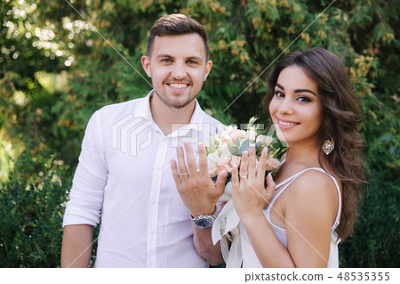 Happy couple show their hands with wedding rings. Groom and bride slime Happy couple show their hands with wedding rings. Groom and bride slime 48535355