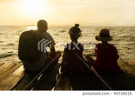 Silhouette of Single dad and daughter sit on raft Silhouette of Single dad and daughter sit on raft 48536616