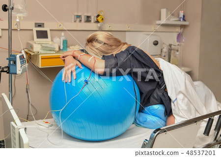 Woman during contractions on a fitness ball Parturition hospital Woman during contractions on a fitness ball Parturition hospital 48537201