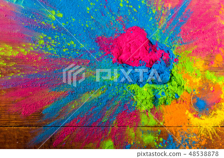 Abstract colorful Happy Holi background. Color vibrant powder on wood. Dust colored splash texture 48538878