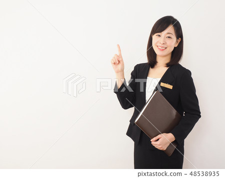 Businesswoman smiling with a file Businesswoman smiling with a file 48538935