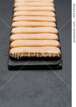 Italian Savoiardi ladyfingers Biscuits on concrete backgound Italian Savoiardi ladyfingers Biscuits on concrete backgound 48539506