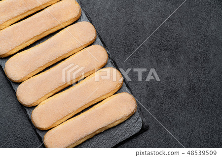 Italian Savoiardi ladyfingers Biscuits on concrete backgound Italian Savoiardi ladyfingers Biscuits on concrete backgound 48539509