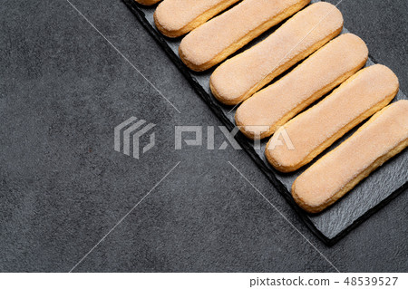 Italian Savoiardi ladyfingers Biscuits on concrete backgound Italian Savoiardi ladyfingers Biscuits on concrete backgound 48539527