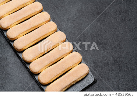 Italian Savoiardi ladyfingers Biscuits on concrete backgound 48539563