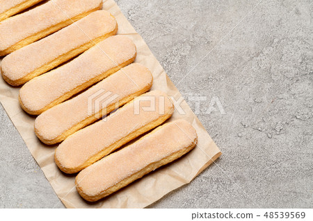 Italian Savoiardi ladyfingers Biscuits on concrete backgound Italian Savoiardi ladyfingers Biscuits on concrete backgound 48539569