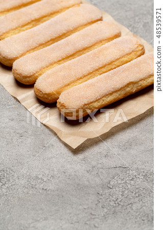 Italian Savoiardi ladyfingers Biscuits on concrete backgound Italian Savoiardi ladyfingers Biscuits on concrete backgound 48539571
