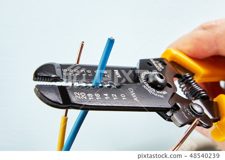 Stripper tool cuts wires during installation. Stripper tool cuts wires during installation. 48540239