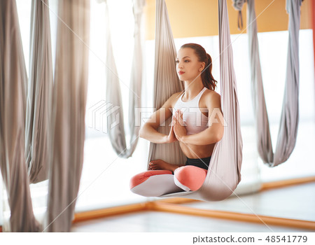 woman doing of Aero yoga of antigravity in hammock 48541779