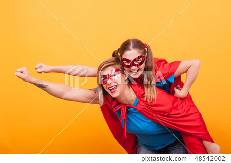 Mother and daughter dressed like superheros flying off to save the world from villans 48542002