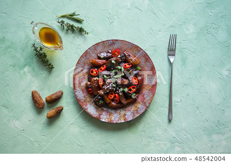 Lamb with figs in a sweet sauce. Asian cuisine. 48542004