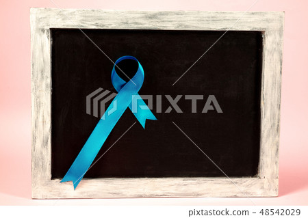 Colon cancer awareness poster. Blue ribbon made of dots on white background. Medical concept. 48542029