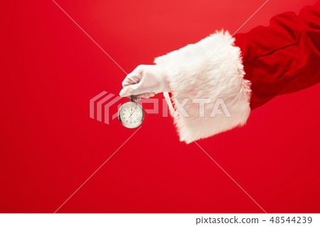Santa holding a stopwatch in hand Santa holding a stopwatch in hand 48544239