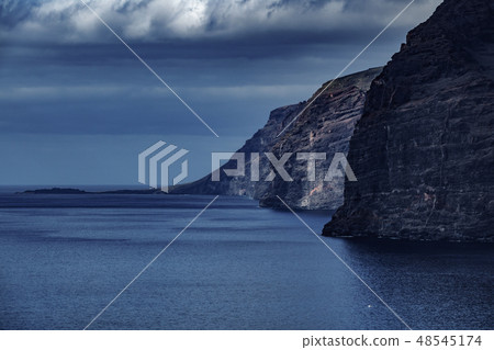 Los Gigantes cliffs dark scene with cloudy sky 48545174