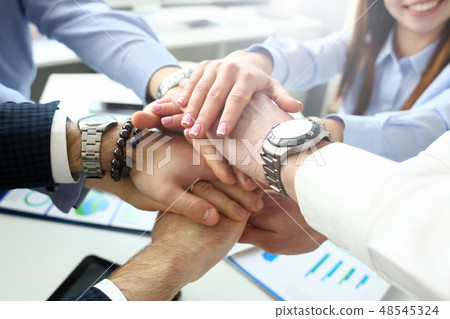 Group of people in suits crossed hands Group of people in suits crossed hands 48545324