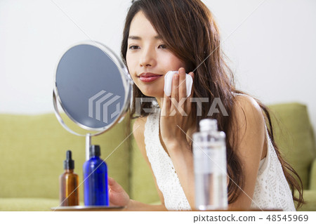 A woman putting lotion A woman putting lotion 48545969