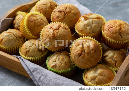 Homemade banana muffins on wooden tray. Homemade banana muffins on wooden tray. 48547152