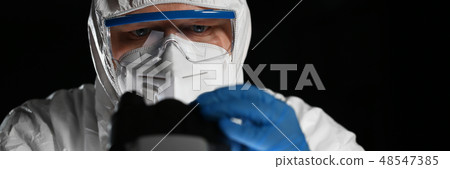 Male chemist in blue protective gloves look Male chemist in blue protective gloves look 48547385