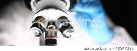 Male chemist in blue protective gloves look Male chemist in blue protective gloves look 48547386